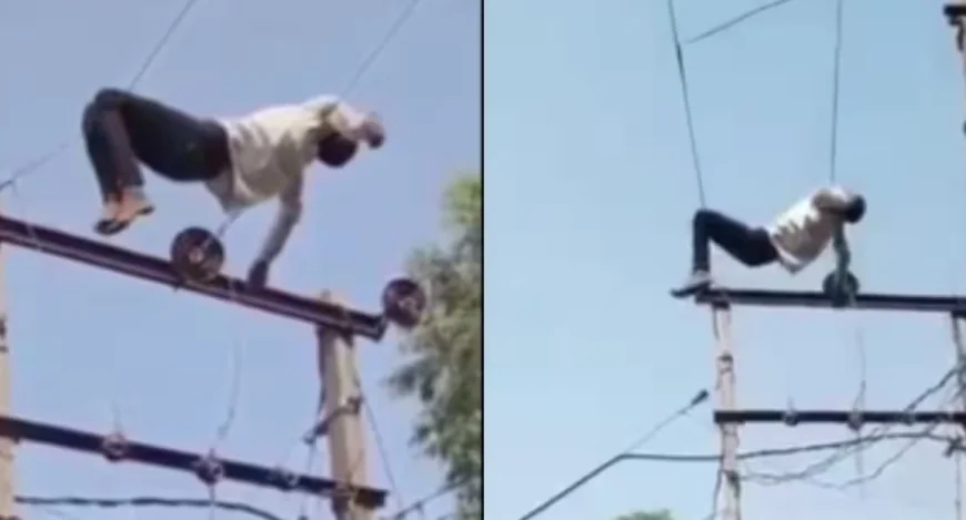 போதை தலைக்கேறி உயர்அழுத்த மின்கம்பியில் ஏறி படுத்த வாலிபர்; அதிர்ச்சியில் உறைந்த பொதுமக்கள்